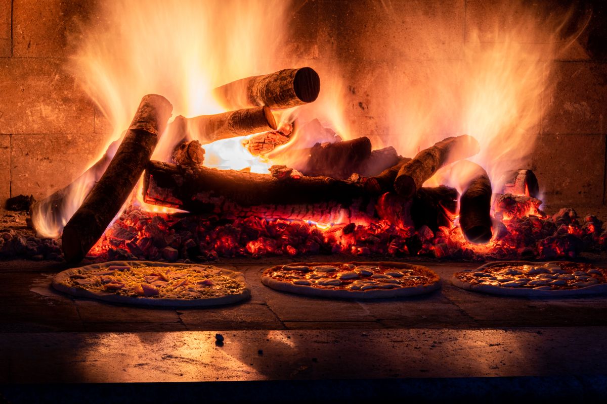 Rustic wood fired oven with pizzas baking
